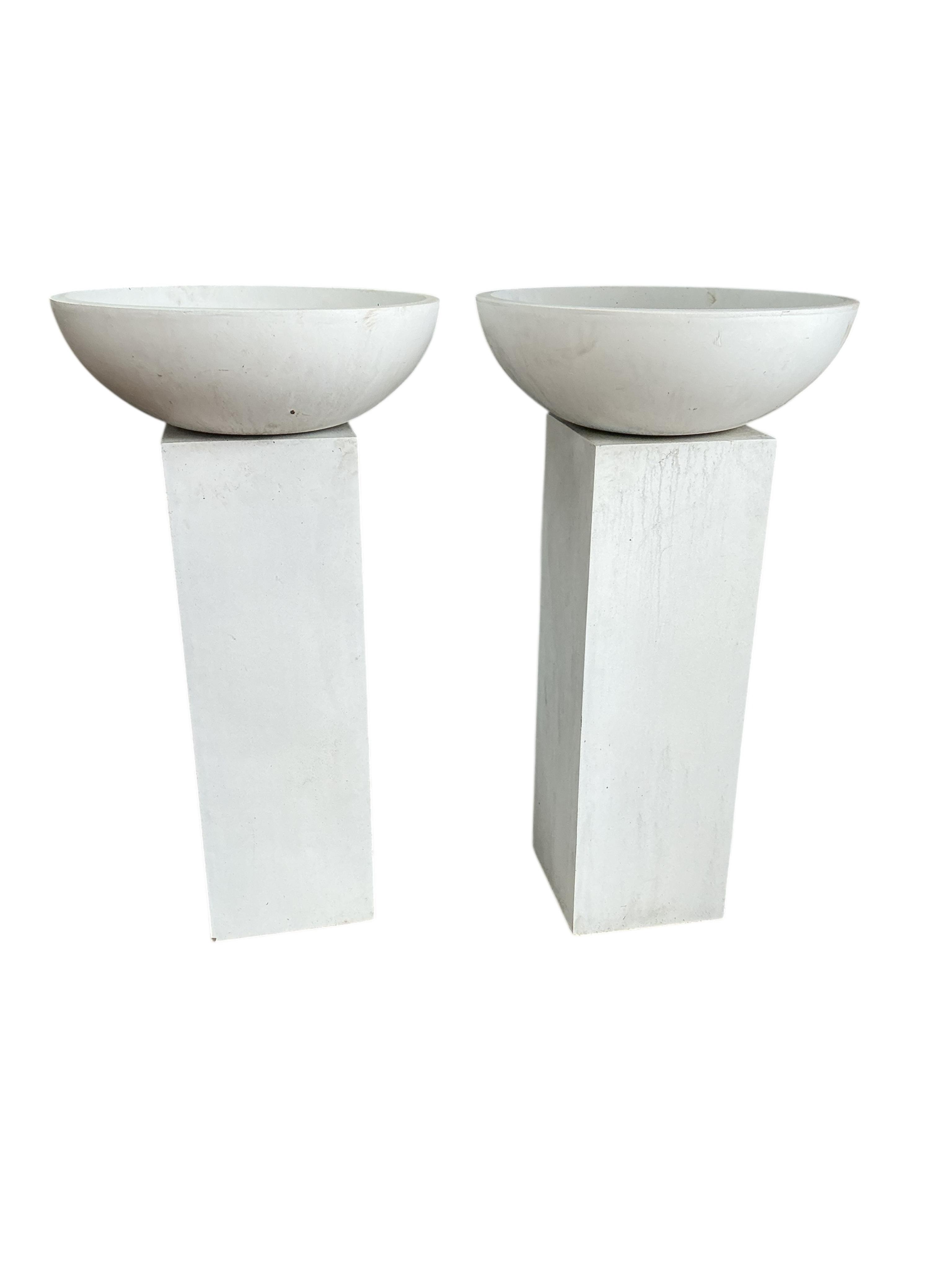 A pair of contemporary circular composition planters on square pedestal bases, diameter 60cm, height 112cm